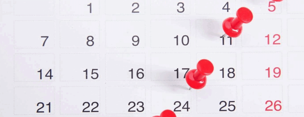 A calendar with red pushpins in it. The 30th is circled.
