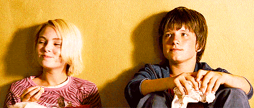 A gif of the two main characters in Bridge to Terabithia smiling at each other