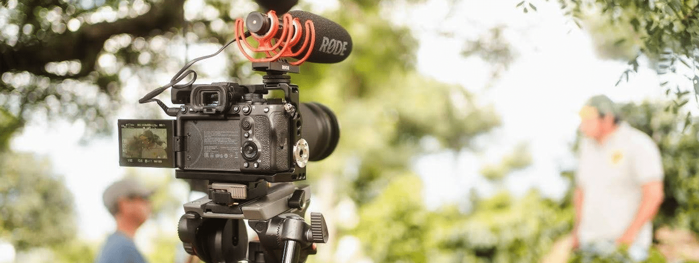 camera on a tripod filming an outdoor scene