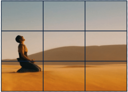 visual example of rule of thirds in film using a still from Mad Max: Fury Road. Furiosa sits left of screen, 2/3 of the screen left negative.