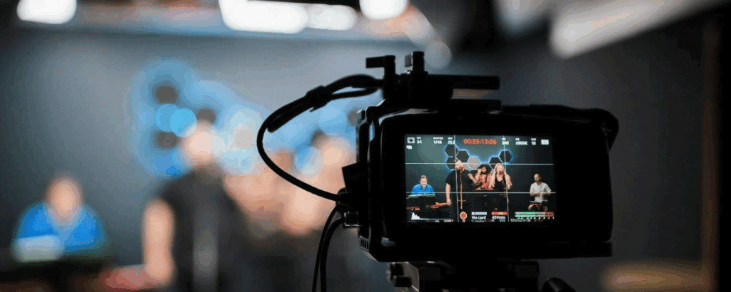 the viewfinder of a camera recording a group of people speaking