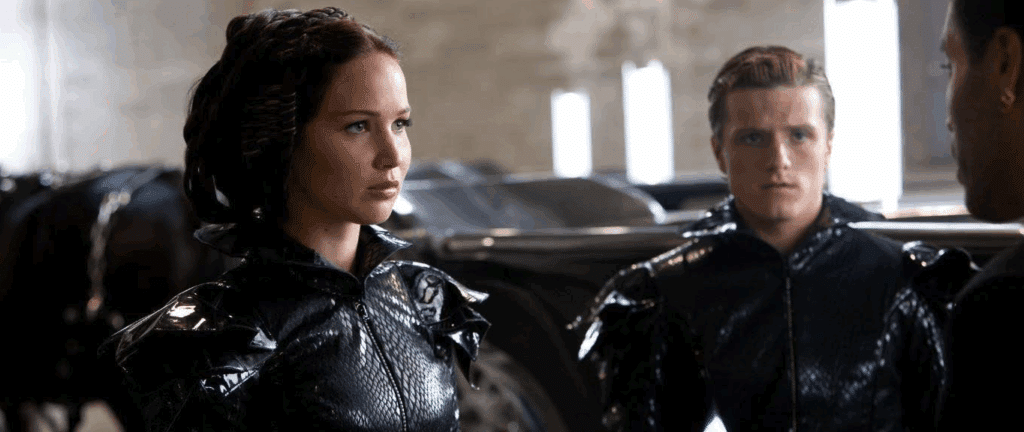 Katniss & Peeta in their matchy-matchy leather gear in The Hunger Games (Katniss is a round character)
