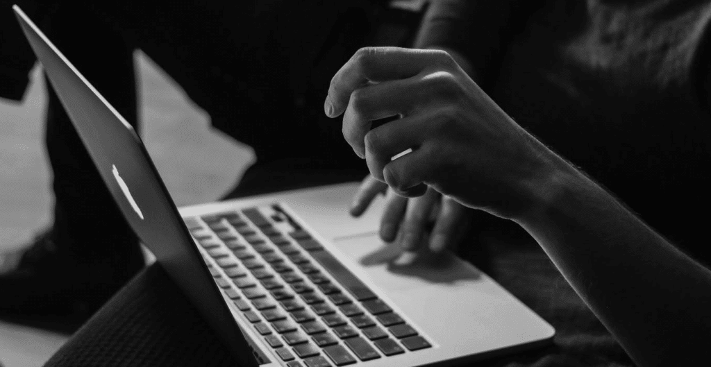 black and white photograph of two hands on a keyboard