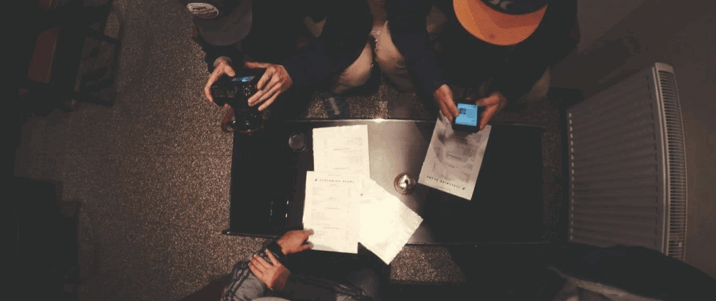 screenplay format

An overhead shot of three people looking down at a screenplay on a table