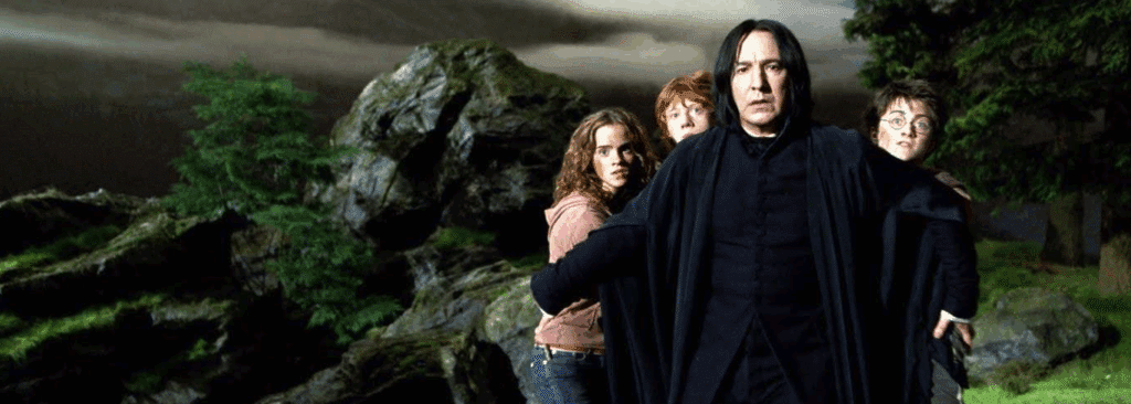 Severus Snape holding back Hermione, Ron, and Harry