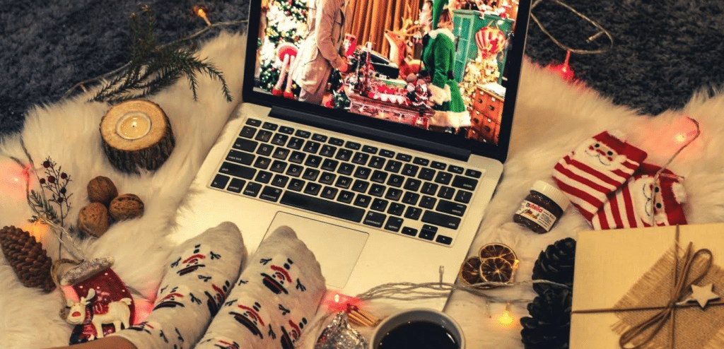 best christmas movies.

Someone wearing Christmas socks watching a Christmas movie on a laptop