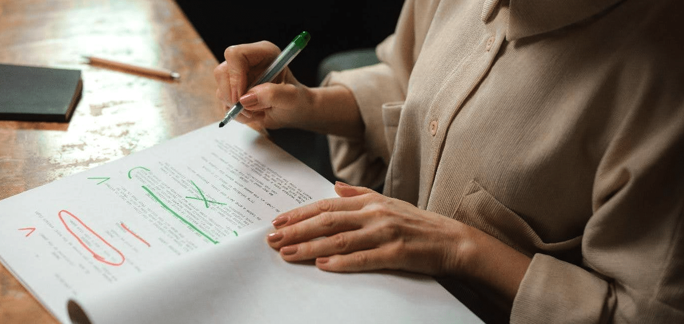close up photo of a woman editing a script by hand
