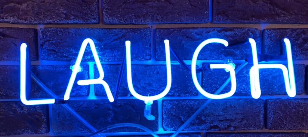 a neon laugh sign